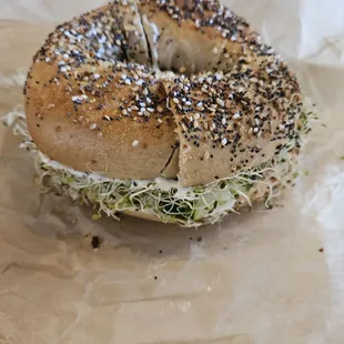 A sprout sandwich with an everything bagel