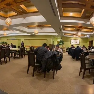 people sitting at tables in a restaurant