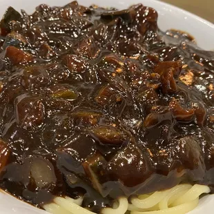 a plate of noodles with meat and sauce