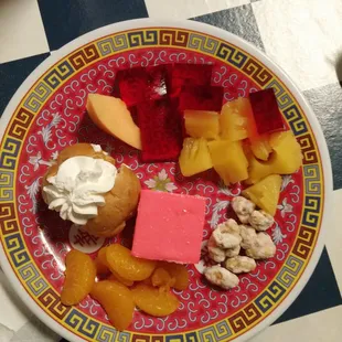 a plate of fruit and desserts