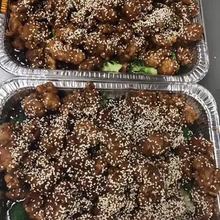 two trays of chinese food