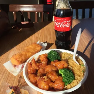 a bowl of food and a bottle of coke