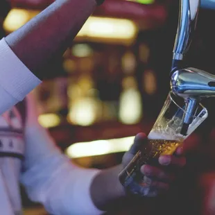 a man pouring a pint of beer
