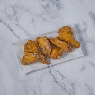 a plate of fried chicken wings