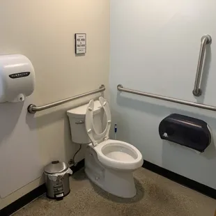 a toilet and hand dryer