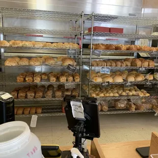 Rack of breads that are cooking off, but you&apos;re still able to buy!