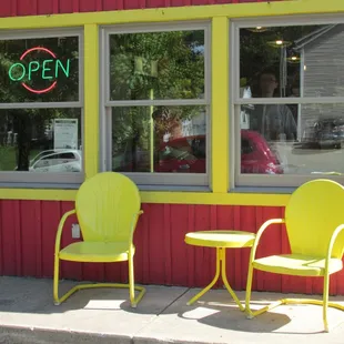 couple of nice yellow chairs at the side entrance to the store