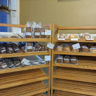 Loaves of quick bread, individually-wrapped muffins/scones, cinnamon snacks, and stacks of cookies are available.