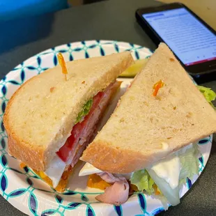 a sandwich on a paper plate