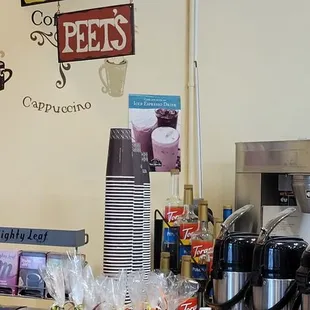 a coffee shop counter with a variety of pastries