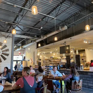 people sitting at tables in a restaurant