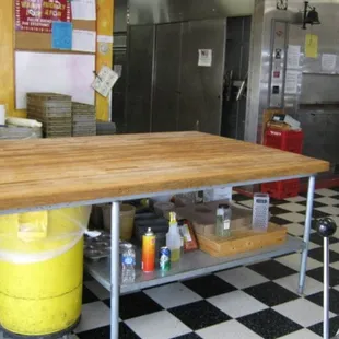 a kitchen area with a table and a stove
