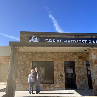 two people standing in front of a building