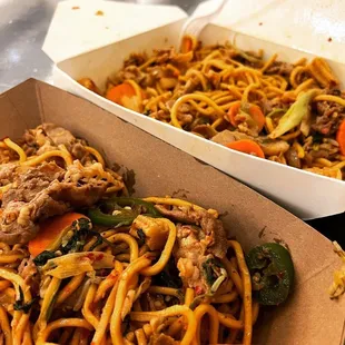 a box of noodles with meat and vegetables