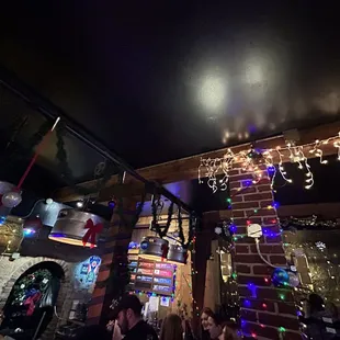 the ceiling decorated with christmas lights