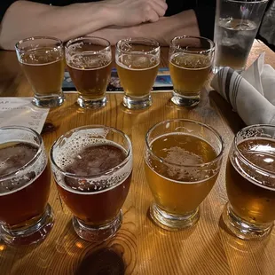 Back: Hop-A-Flight, Front: Flight of 4. LTR: Dortmunder Gold Lager, Tropicoastal Tropical IPA, Christmas Ale, Eliot Ness Amber Lager