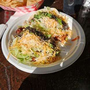 Carnitas and al pastor tacos with chips.