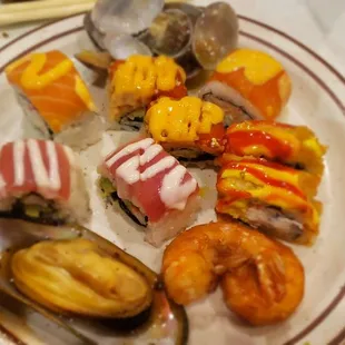 a plate of sushi and shrimp
