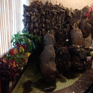 a waterfall of rocks and flowers