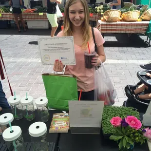 a young woman holding a cup of coffee