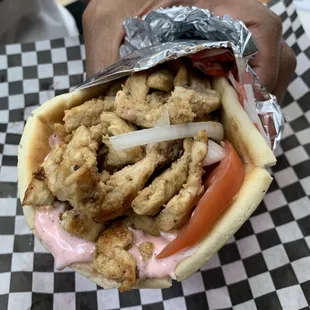 Close-up of the Chicken Shawarma Pita. The tzatziki appears pink but I promise it&apos;s tastes as it should &amp; full of flavor!