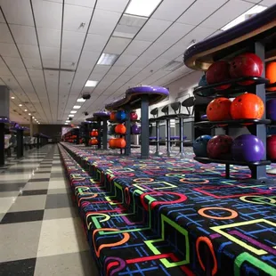 bowling balls lined up on benches