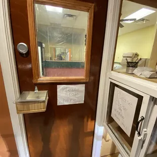 Covid precautions. Door on the left has a spot for payments. Cabinet on the right is the food pass through.