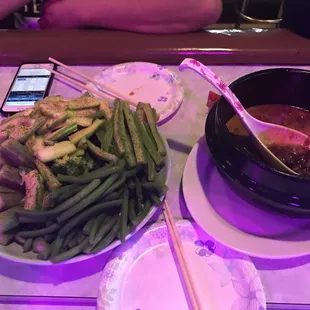 a bowl of soup and a plate of green beans