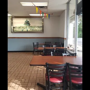 a dining area with tables and chairs