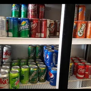 a refrigerator full of sodas and soft drinks