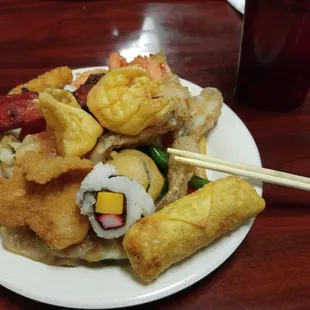 a plate of food and chopsticks
