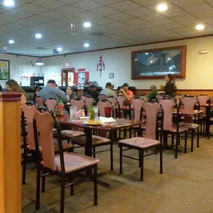 people sitting at tables in a restaurant