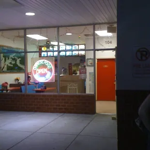 a man standing in front of a restaurant