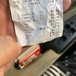 a hand holding a receipt