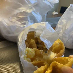 a person holding a piece of food