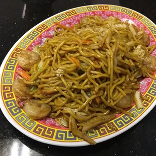 a plate of noodles and shrimp