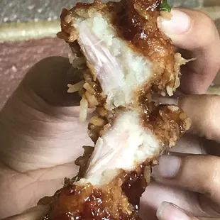 a person holding a piece of food