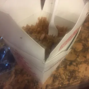 a box of food with a fork sticking out of it