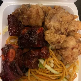 chicken, noodles, and vegetables in a styrofoam container