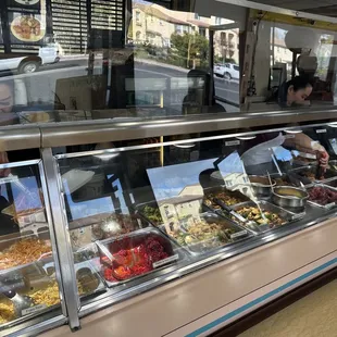 a variety of food in a display case