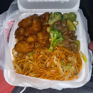 a takeout box of chinese food