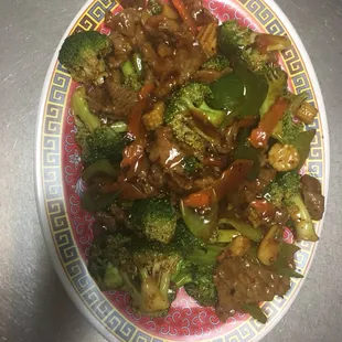 a plate of stir fried beef and broccoli