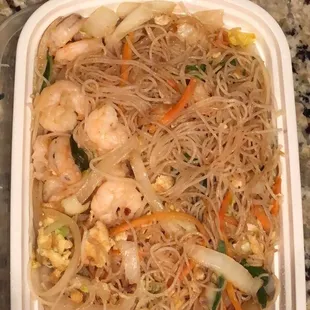 a bowl of noodles with shrimp and vegetables