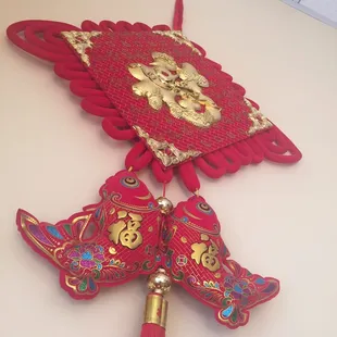 a red fan with gold decorations
