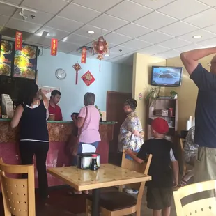 people standing and sitting at tables