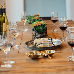 a table set with wine glasses and plates