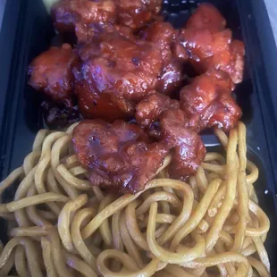 a plate of noodles and meat
