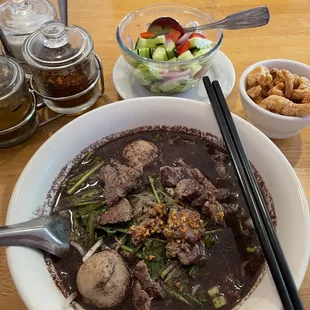 Boat salad (Boat Noodle Beef) with crispy pork skins and Cucumber Salad