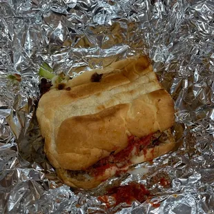 a sandwich wrapped in tin foil