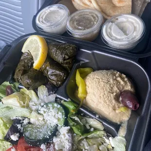 Side plate with dolmades, hummus and pita, and Greek salad